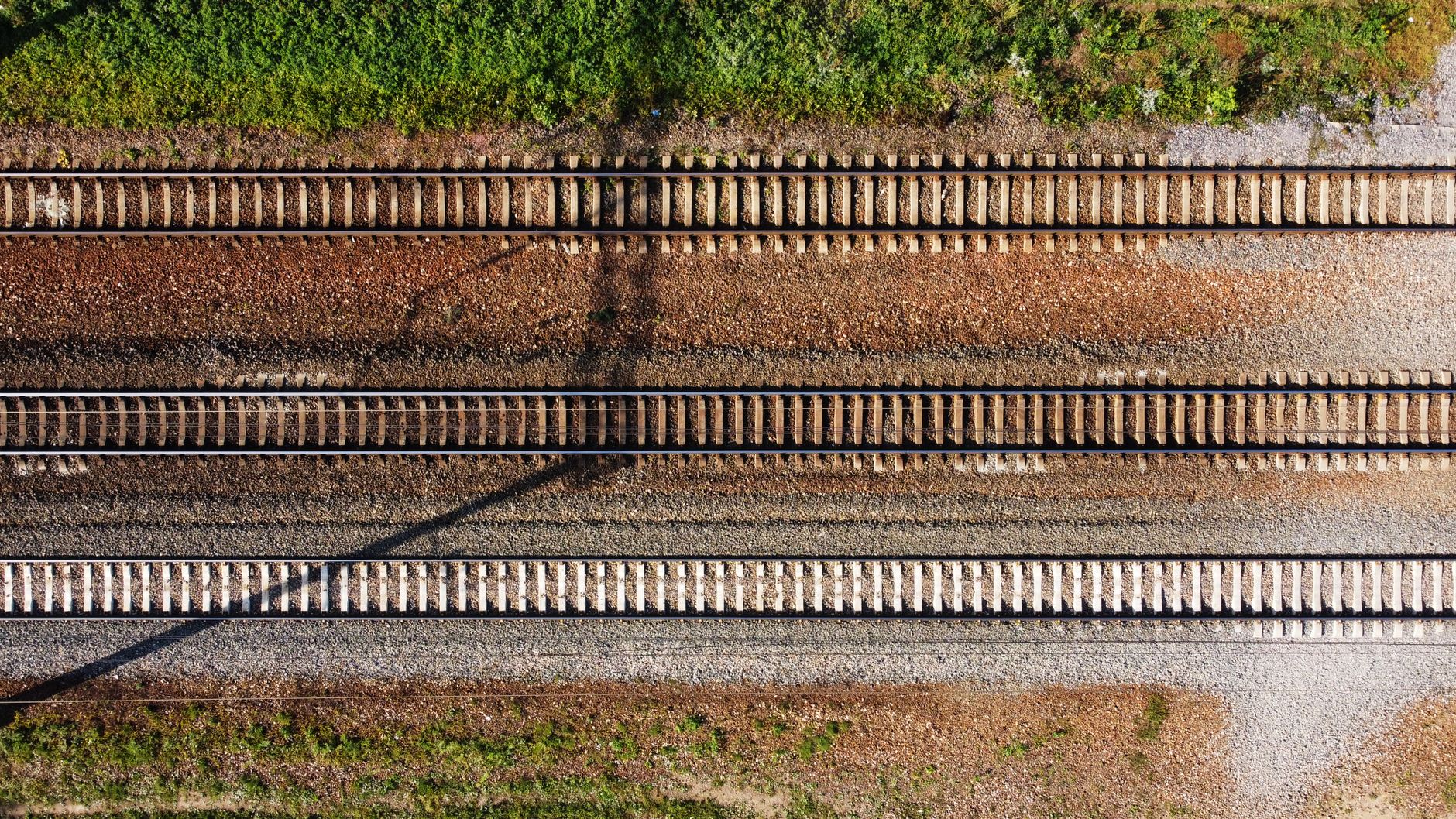 Drone shot of intersecting railway tracks in a green landscape, Russia.