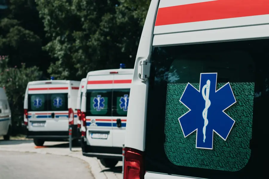 Three ambulances parked outdoors, ready for emergency healthcare situations.
