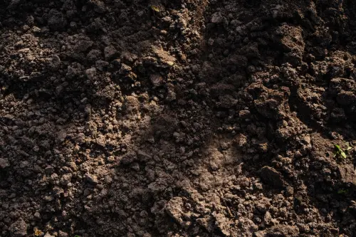 Detailed view of freshly tilled soil, perfect for planting in agriculture and gardening.