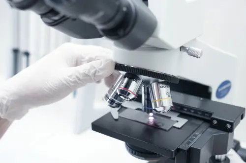 A detailed view of a microscope being used in a modern laboratory.