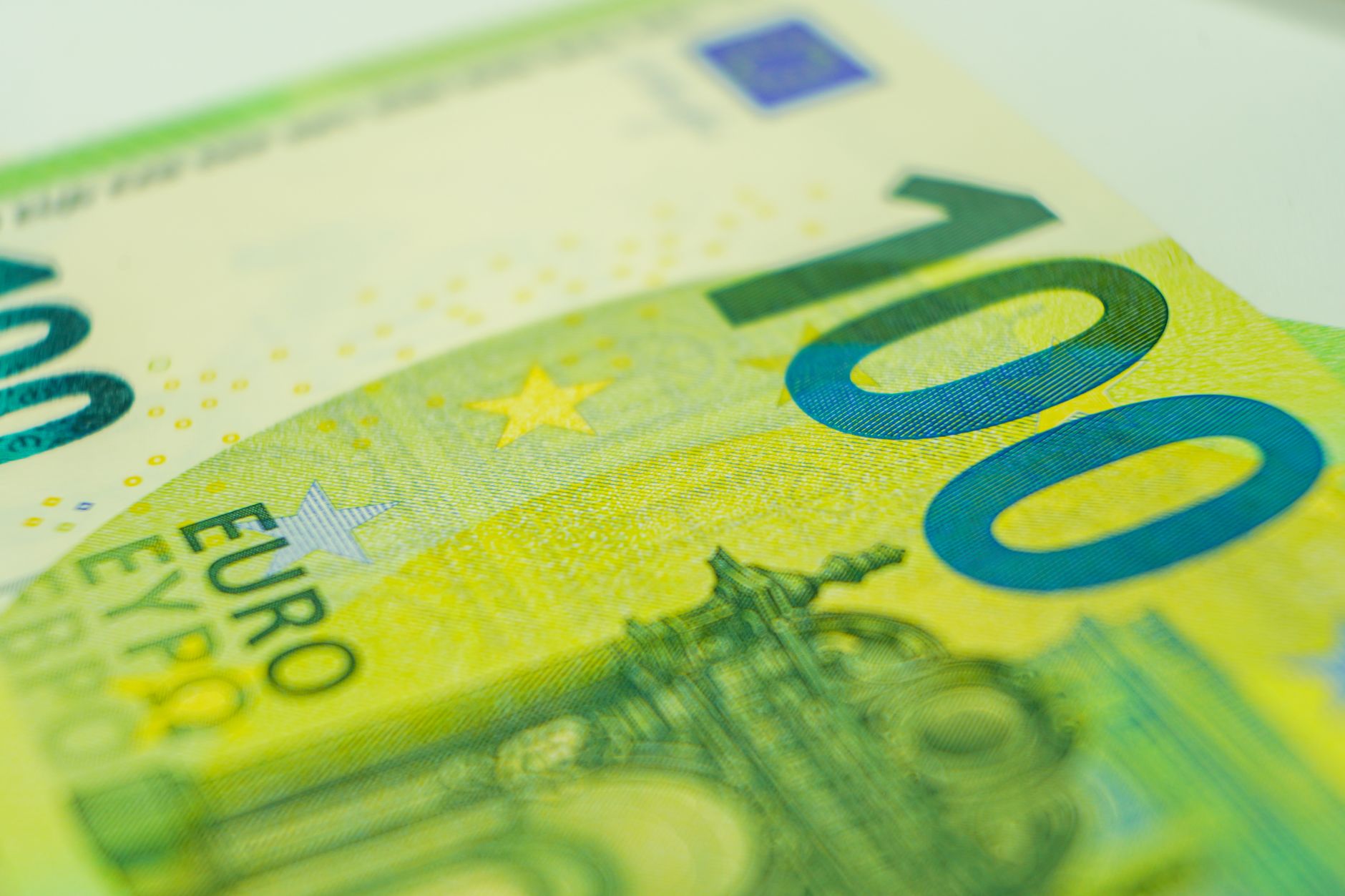 Detailed close-up of a 100 euro banknote showcasing currency details.